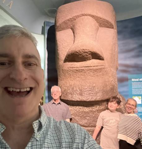Jared with group in front of Easter Island Head at a NYC Museum